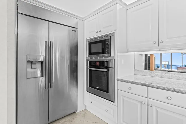 a bedroom with a large bed and a flat tv screen on dresser