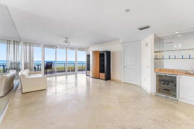 a kitchen with white cabinets and sink