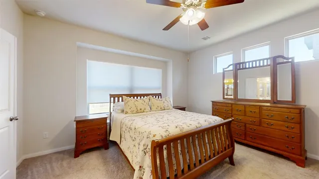 a bedroom with a bed and a dresser