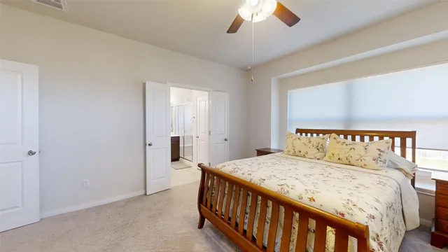 a bedroom with a large bed and a chandelier