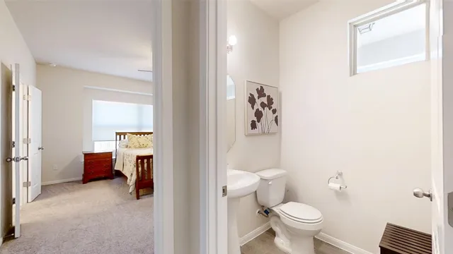 a bathroom with a toilet and a shower curtain