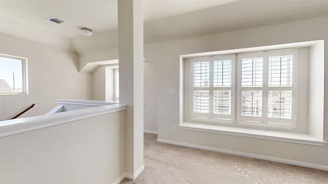 a room with a window and a kitchen view