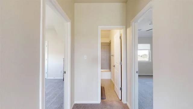 a view of a bathroom from a hallway