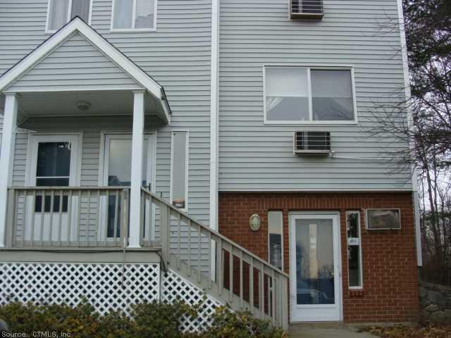 a view of a house with wooden door and deck