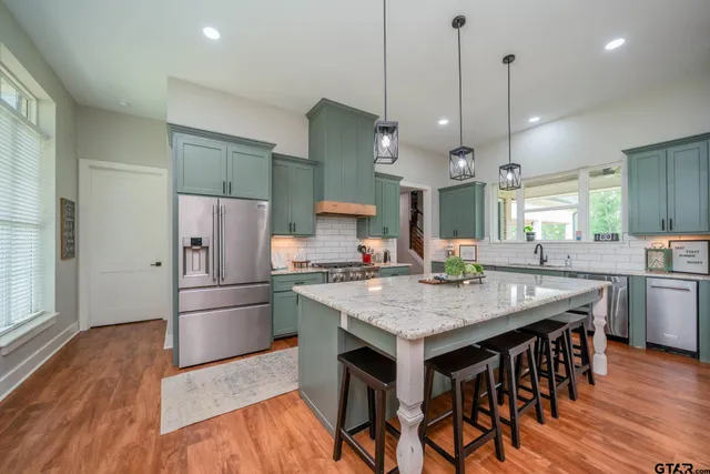 a kitchen with center island and wooden floors