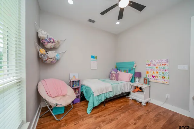 a bedroom with a bed and wooden floor