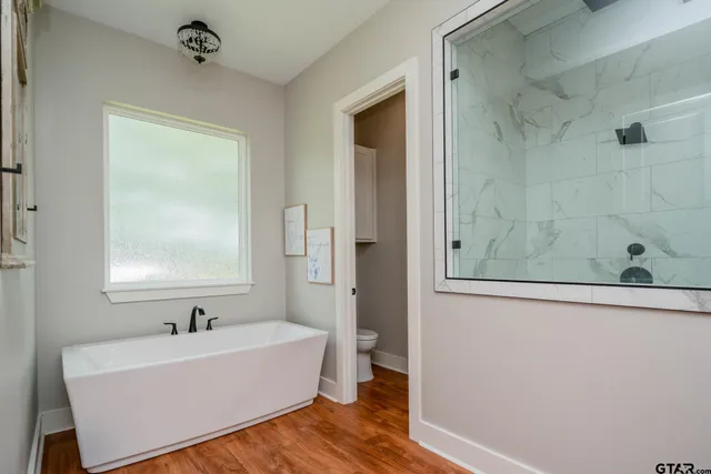 a view of room with window and wooden floor