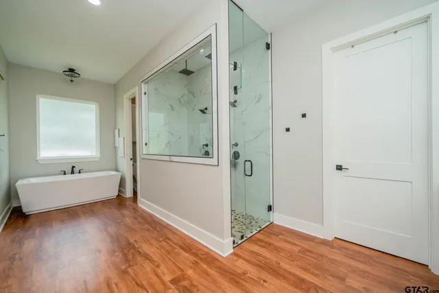 a bathroom with a double vanity sink mirror and shower