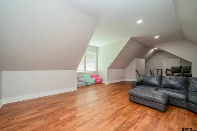 a view of a room with wooden floor and furniture