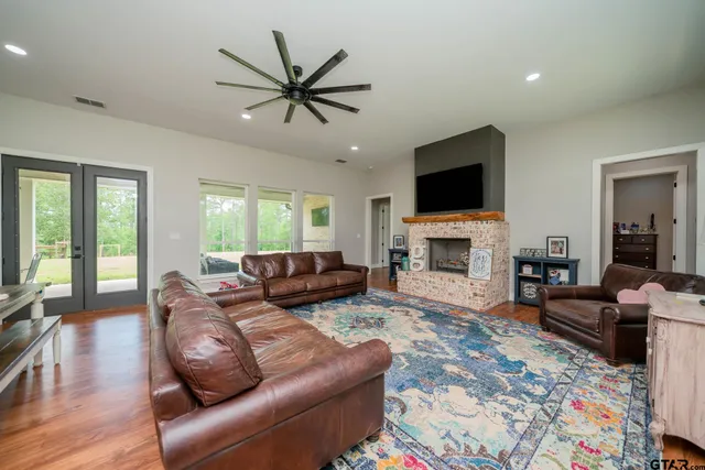 a living room with furniture and wooden floor
