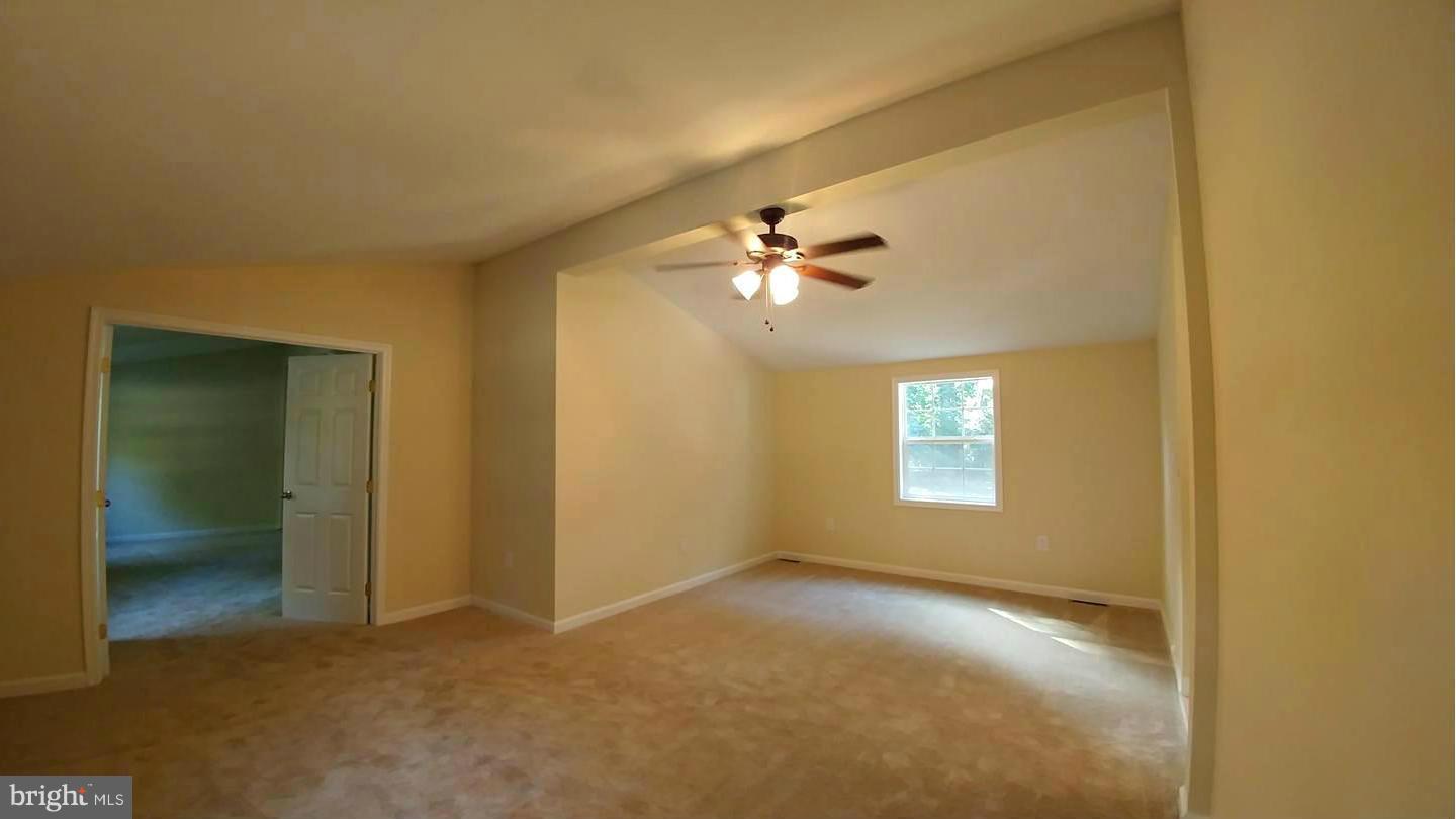 7435 Simms Landing Road Port Tobacco, MD 20677 - Photo 14 of 26 a view of an empty room with window and chandelier fan