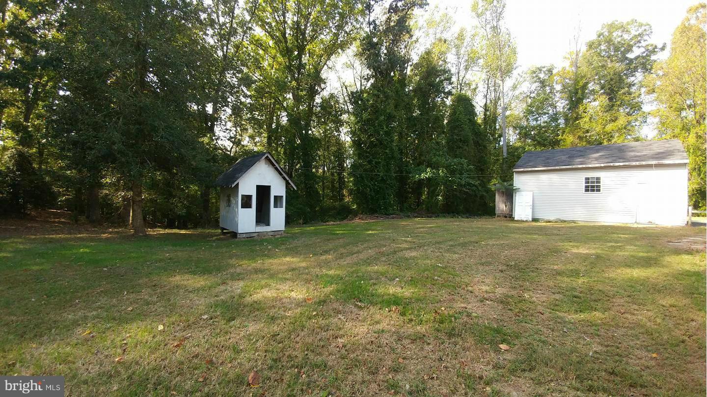 7435 Simms Landing Road Port Tobacco, MD 20677 - Photo 15 of 26 a house with huge green field with wooden fence