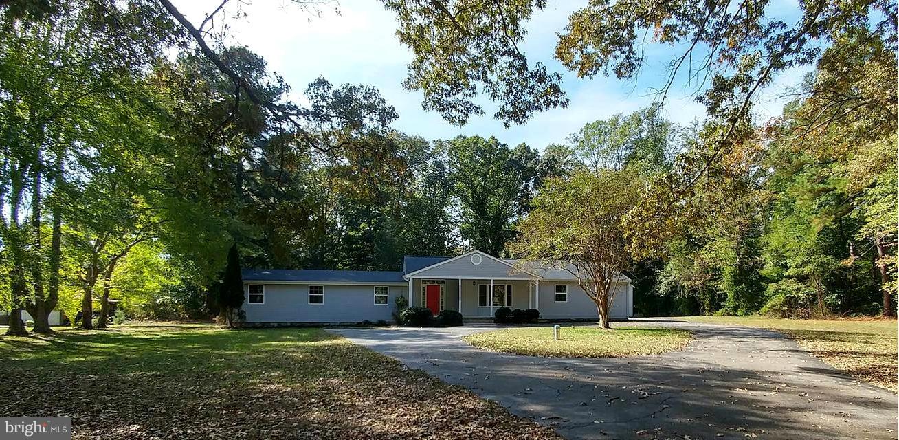 7435 Simms Landing Road Port Tobacco, MD 20677 - Photo 22 of 26 a front view of a house with a yard