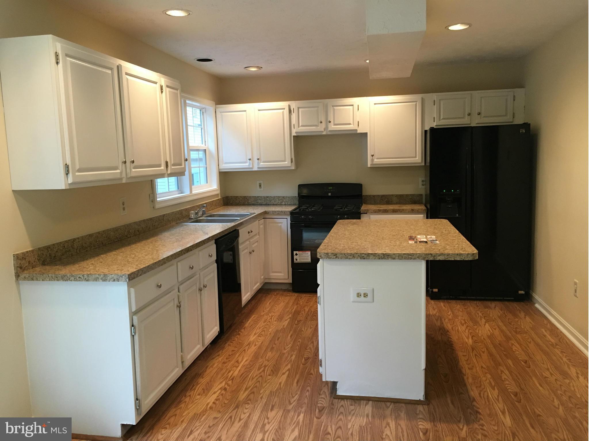 7435 Simms Landing Road Port Tobacco, MD 20677 - Photo 4 of 26 a kitchen with a sink cabinets and wooden floor