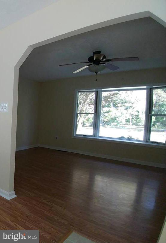 7435 Simms Landing Road Port Tobacco, MD 20677 - Photo 5 of 26 a view of an empty room with a window and wooden floor
