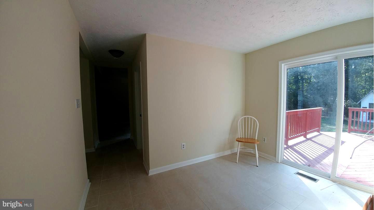 7435 Simms Landing Road Port Tobacco, MD 20677 - Photo 7 of 26 wooden floor and chair in a room