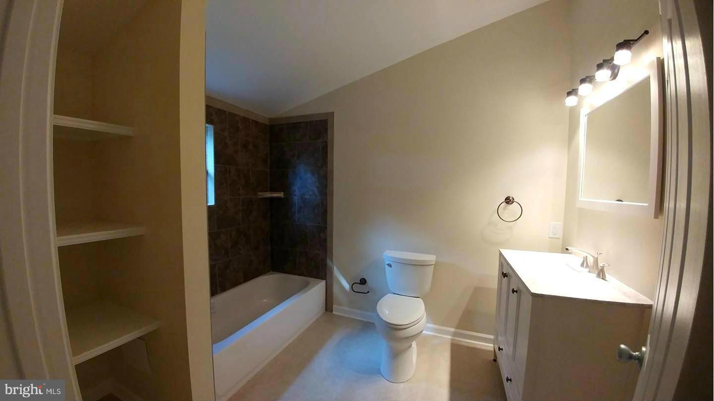 7435 Simms Landing Road Port Tobacco, MD 20677 - Photo 10 of 26 a bathroom with a sink a toilet and shower