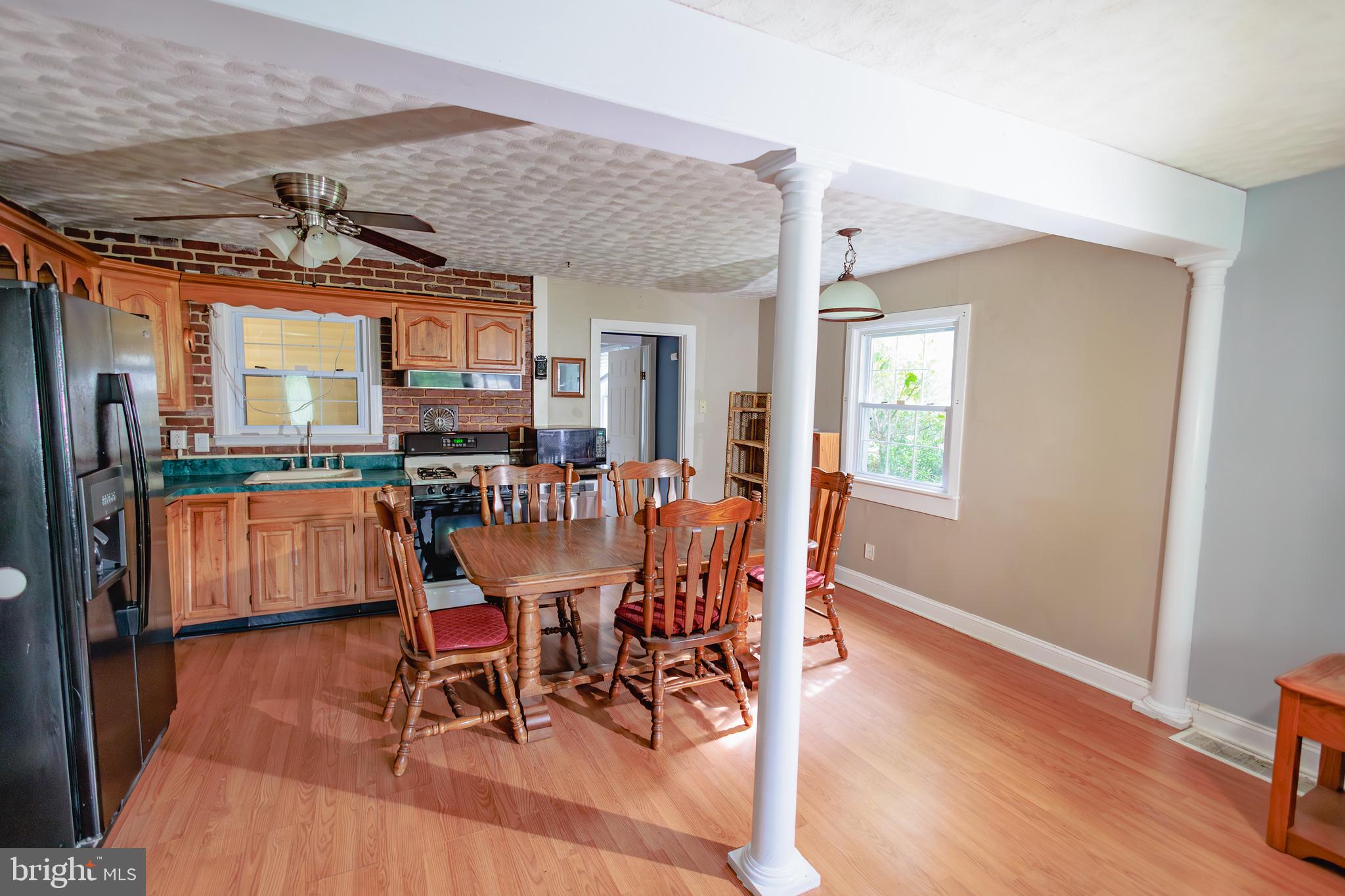 419 University Boulevard Glassboro, NJ 08028 - Photo 12 of 30 a dining room with furniture a chandelier and wooden floor