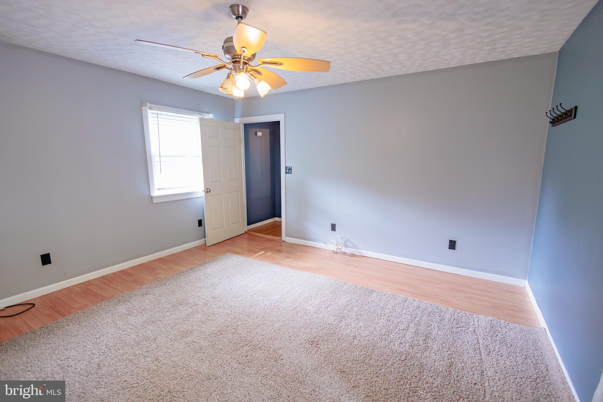 419 University Boulevard Glassboro, NJ 08028 - Photo 16 of 30 an empty room with a window and a chandelier fan