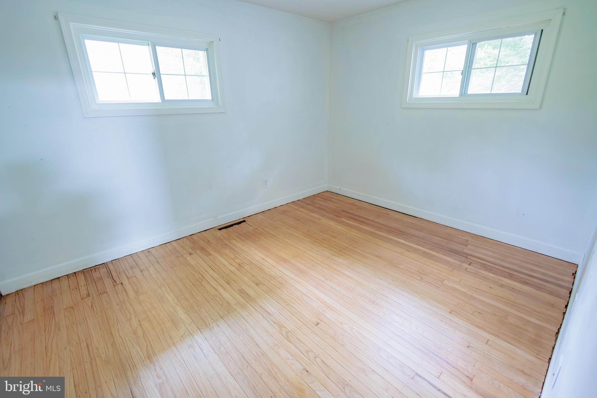 419 University Boulevard Glassboro, NJ 08028 - Photo 23 of 30 an empty room with wooden floor and windows
