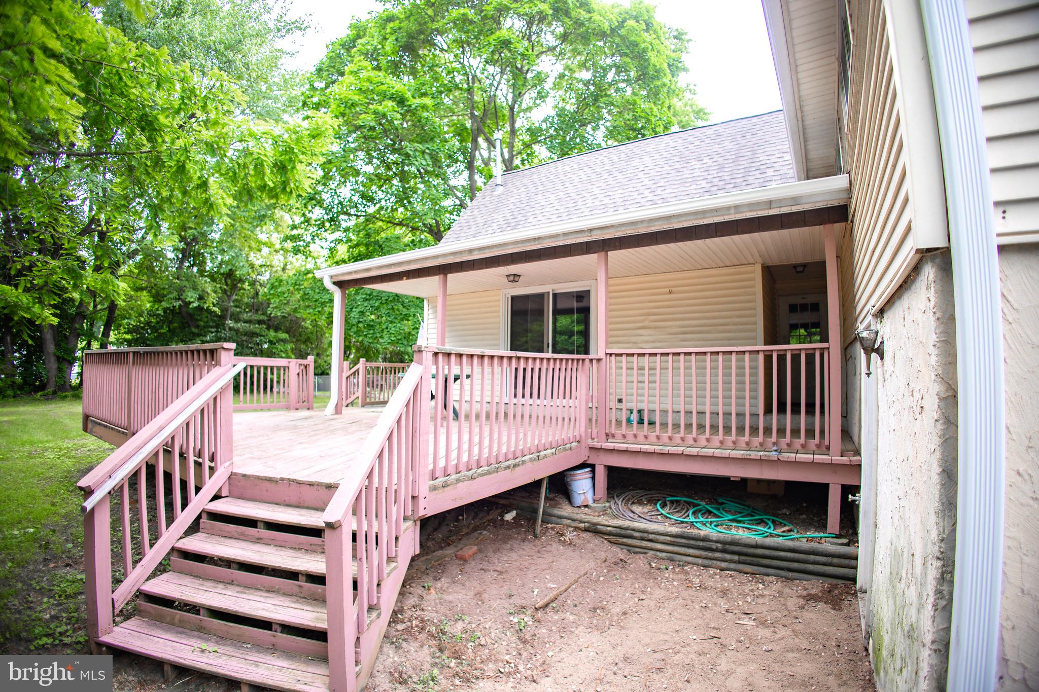 419 University Boulevard Glassboro, NJ 08028 - Photo 4 of 30 a view of a house with wooden deck and wooden fence