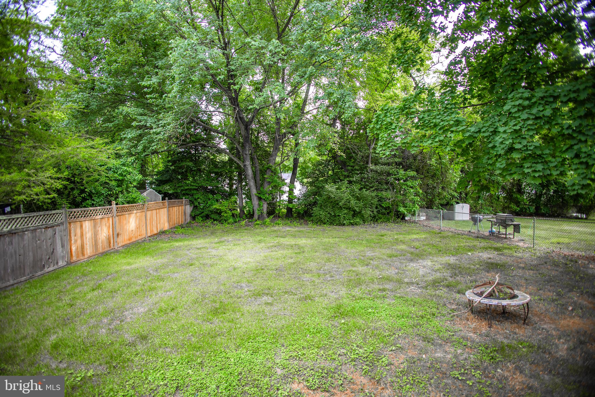 419 University Boulevard Glassboro, NJ 08028 - Photo 7 of 30 a view of a backyard with a wooden fence