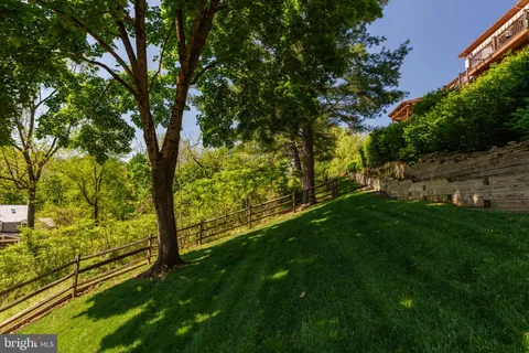 an aerial view of a house with a yard swimming pool and outdoor seating