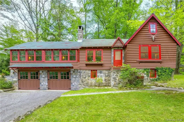 a view of a house with a yard and a garden