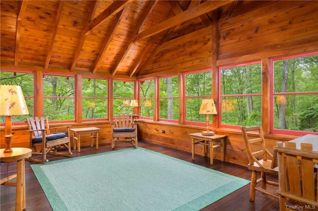 a room with pool table and windows