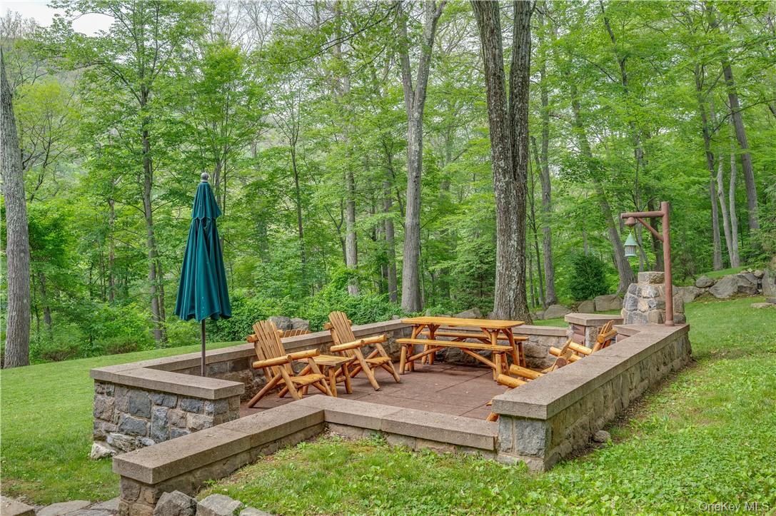 77 Lake Drive Cold Spring, NY 10516 - Photo 27 of 49 a view of a patio with a table chairs and a backyard