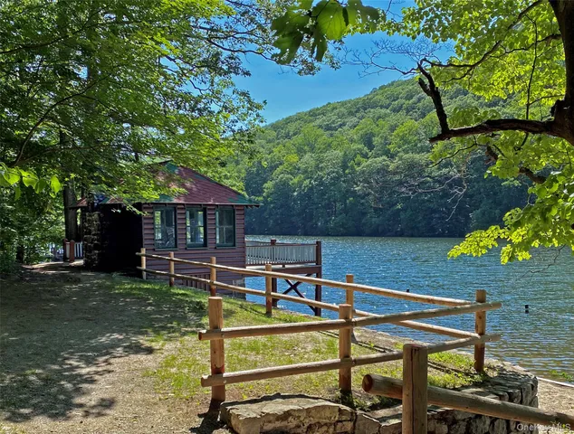 a balcony with wooden floor and outdoor seating