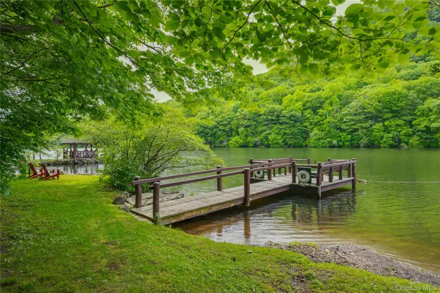 a view of a house with a yard from a lake view