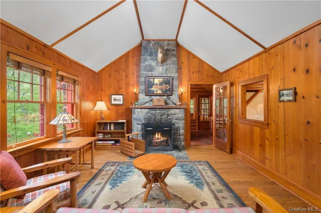 a living room with fireplace furniture and a floor to ceiling window