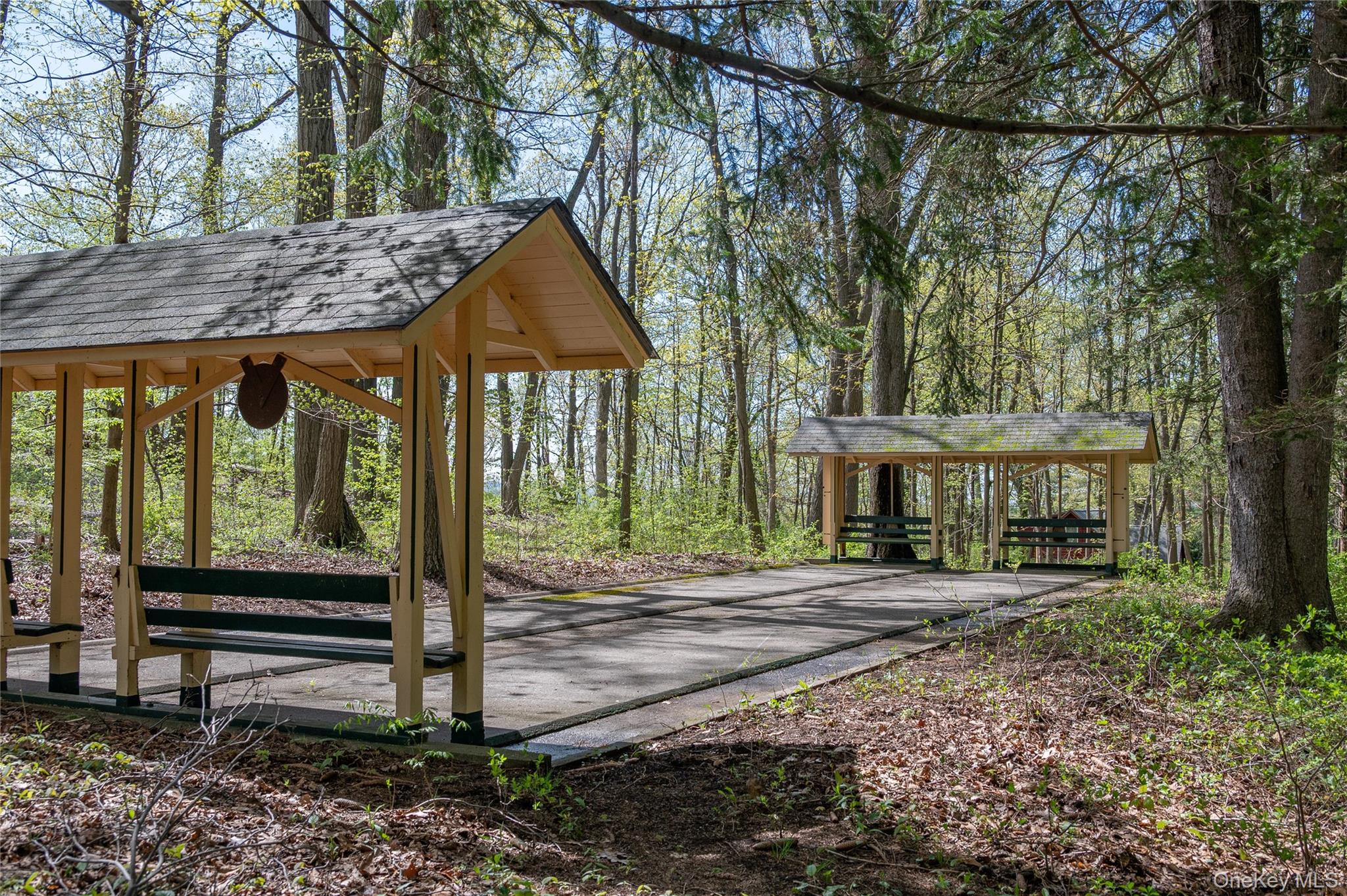 77 Lake Drive Cold Spring, NY 10516 - Photo 46 of 49 a backyard of a house with barbeque oven table and chairs