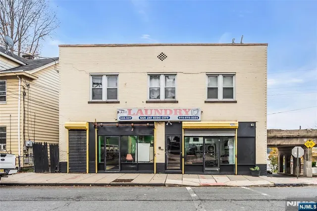 a kitchen with granite countertop a stove sink and microwave