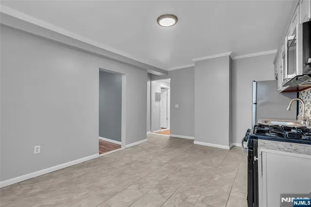 a view of a livingroom with an empty space and a window