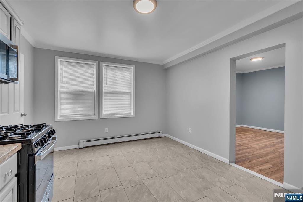 537 Scotland Road, Unit 2 Orange, NJ 07050 - Photo 5 of 17 a view of a livingroom with an empty space and a window