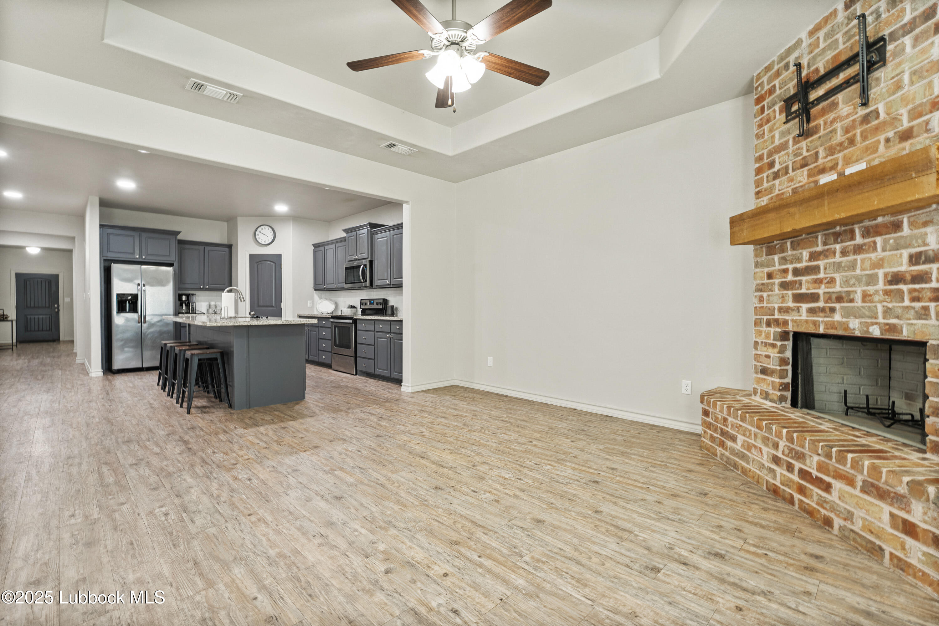 5303 Lehigh Street Lubbock, TX 79416 - Photo 12 of 31 a view of kitchen with kitchen island wooden floor center island and stainless steel appliances