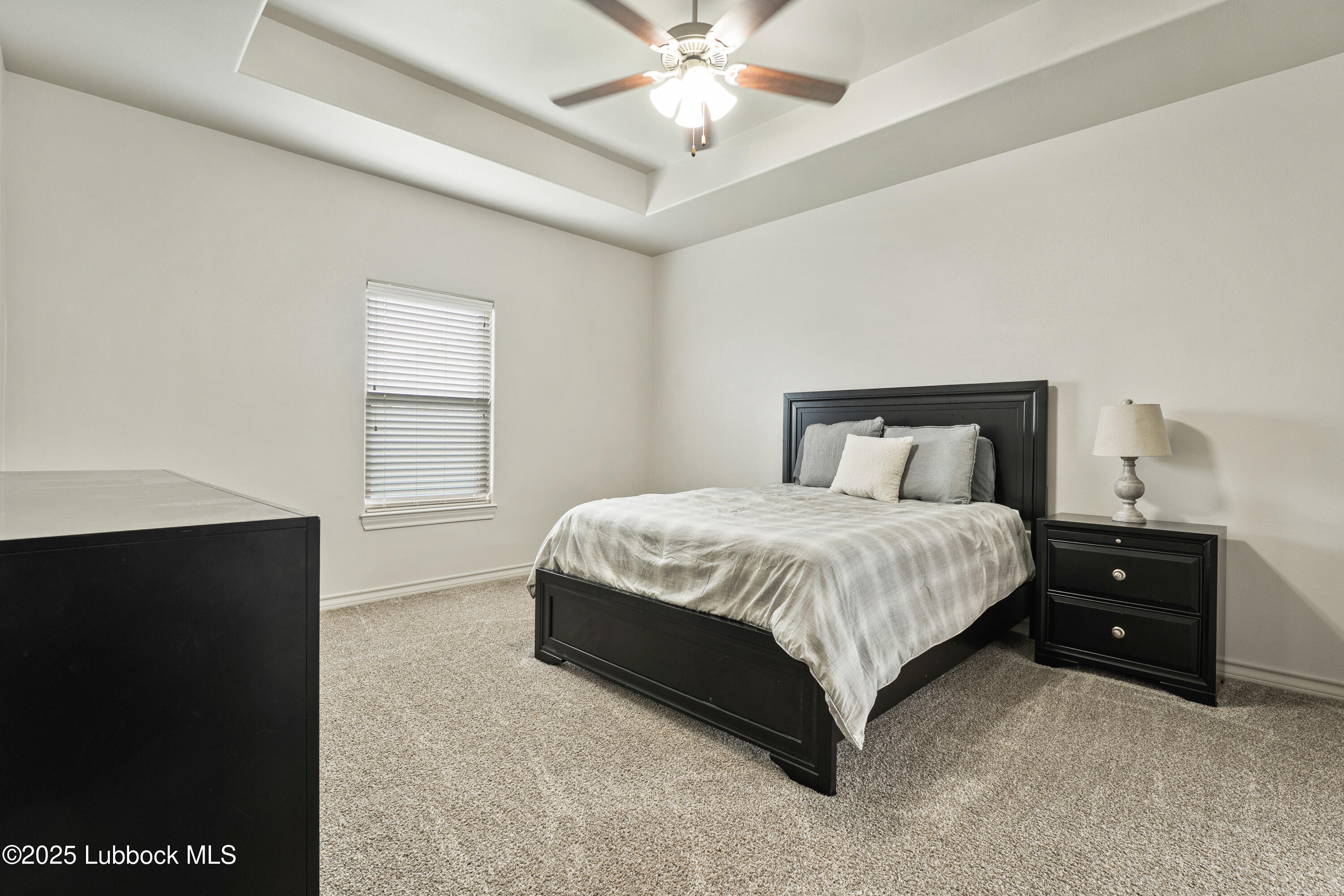 5303 Lehigh Street Lubbock, TX 79416 - Photo 14 of 31 a bedroom with a bed and a ceiling fan