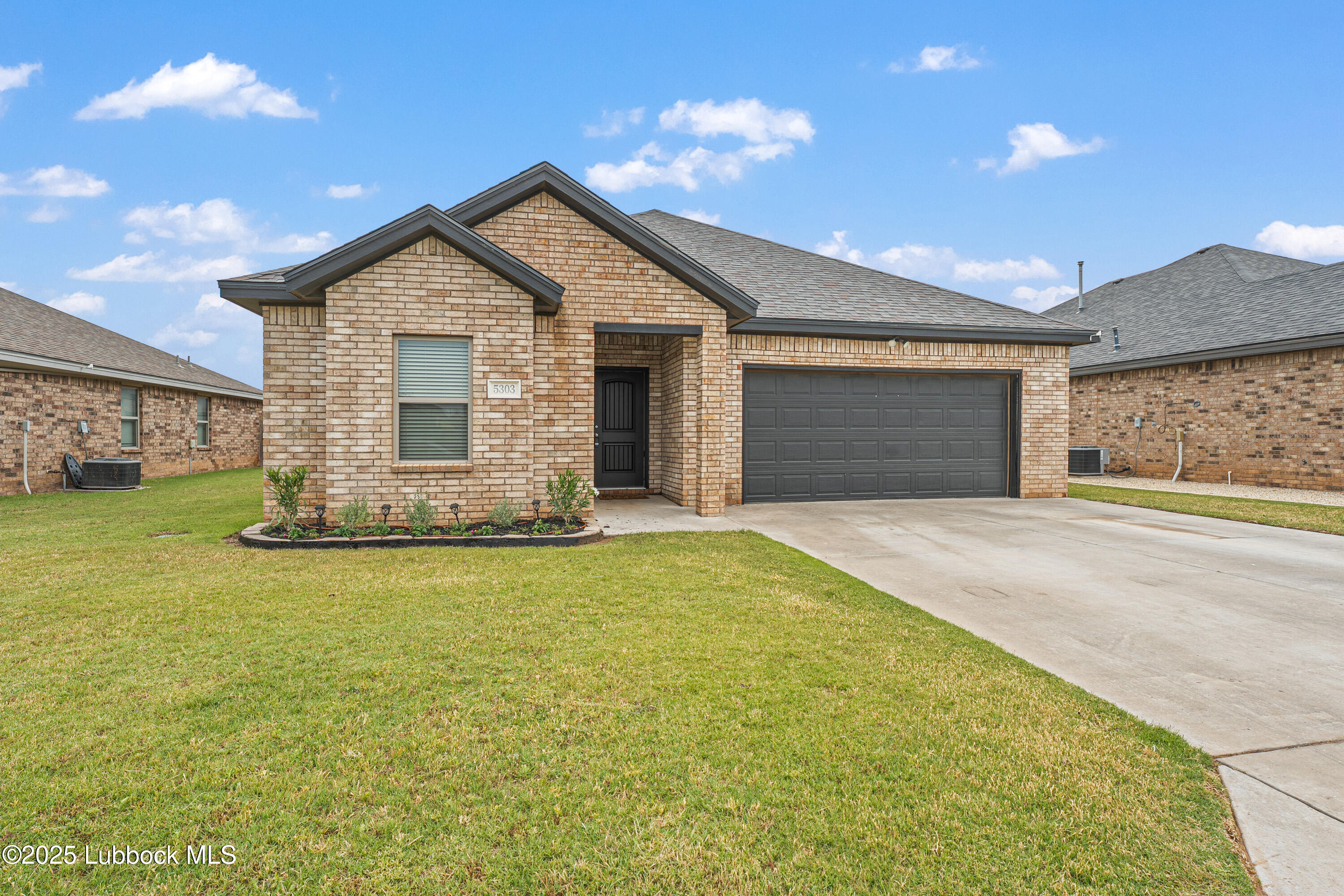 5303 Lehigh Street Lubbock, TX 79416 - Photo 2 of 31 a view of a house with a yard and garage