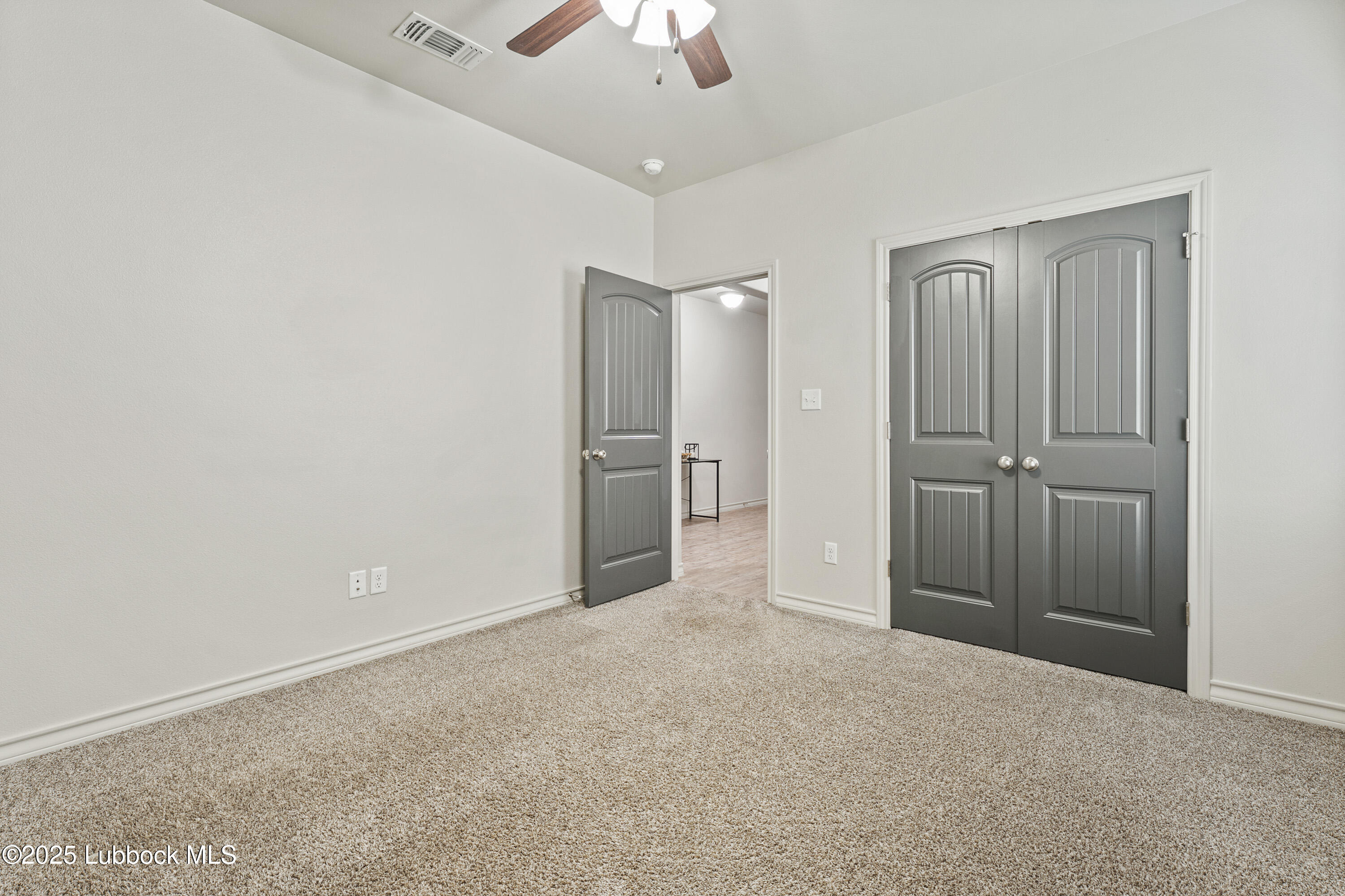 5303 Lehigh Street Lubbock, TX 79416 - Photo 23 of 31 an empty room with closet and a ceiling fan
