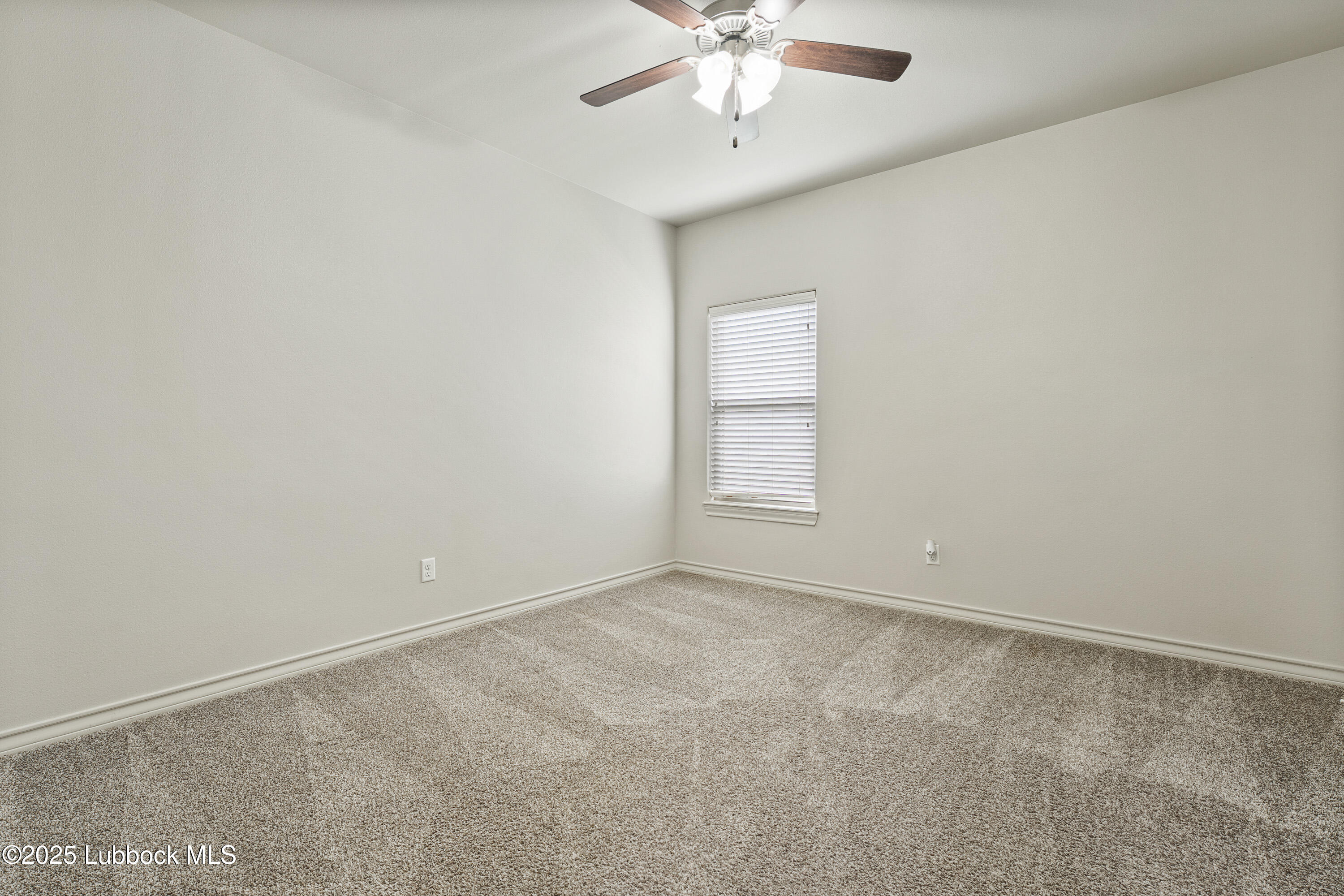 5303 Lehigh Street Lubbock, TX 79416 - Photo 27 of 31 an empty room with a chandelier fan