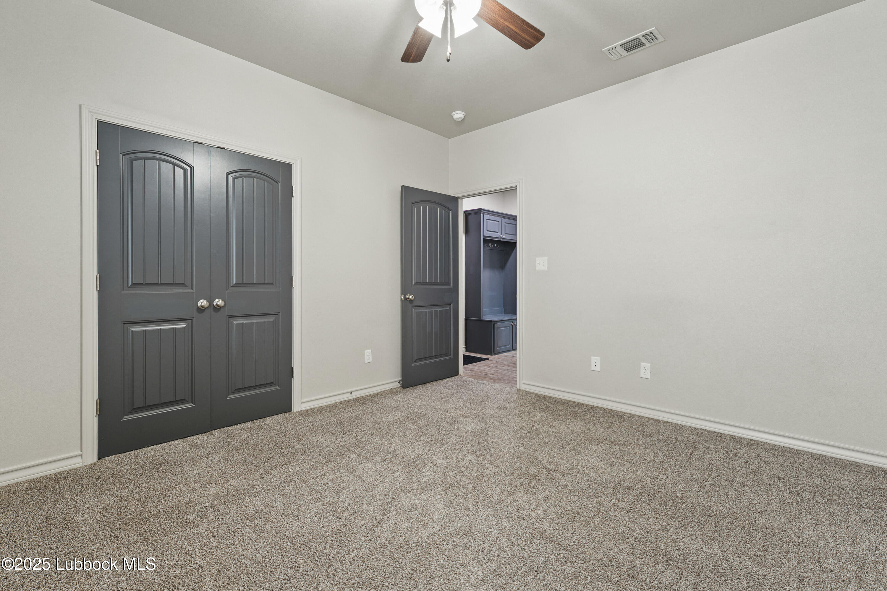 5303 Lehigh Street Lubbock, TX 79416 - Photo 28 of 31 an empty room with closet and a chandelier fan