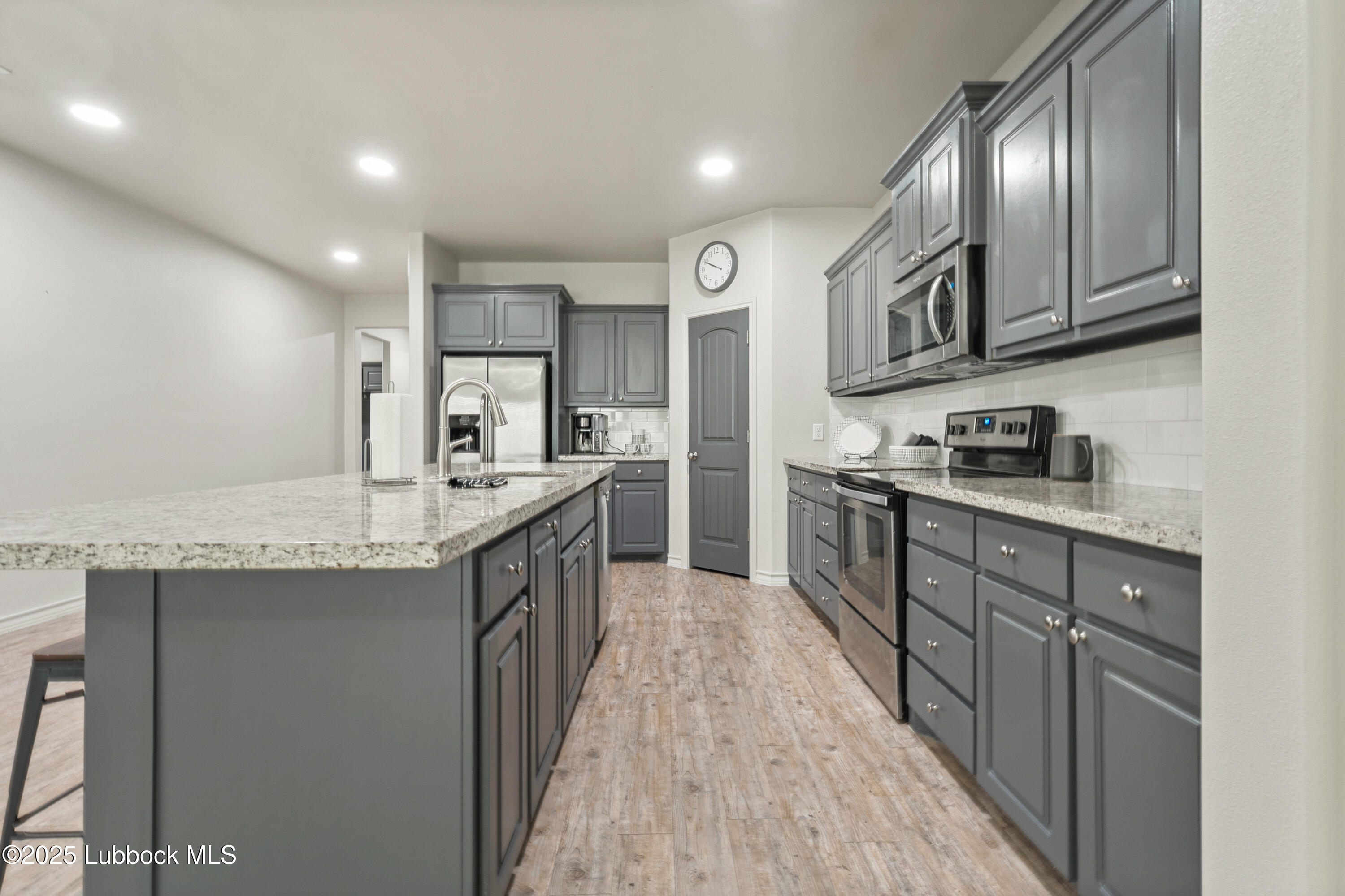 5303 Lehigh Street Lubbock, TX 79416 - Photo 8 of 31 a kitchen with stainless steel appliances granite countertop lots of counter top space and cabinets