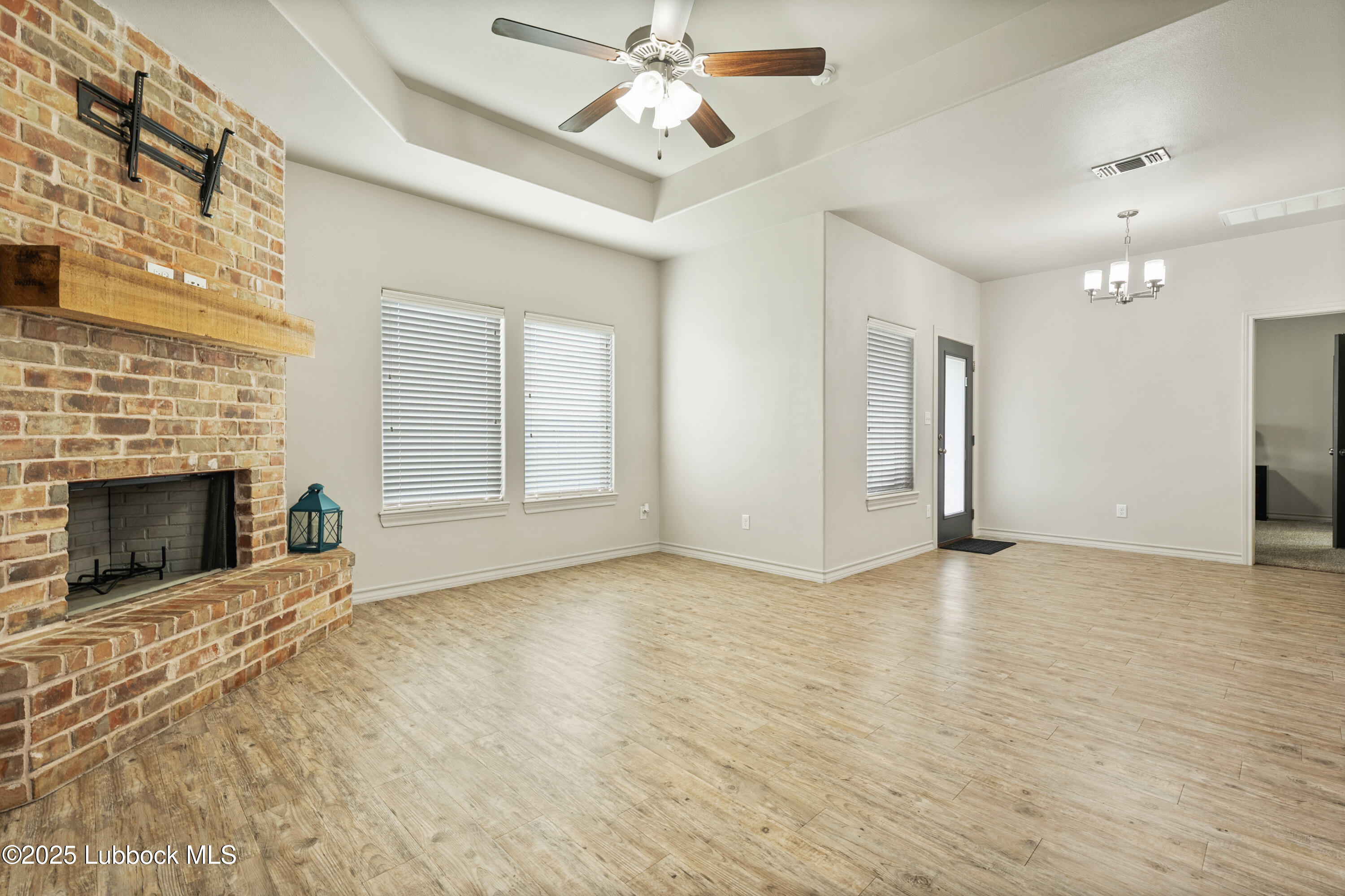 5303 Lehigh Street Lubbock, TX 79416 - Photo 10 of 31 a view of an empty room with window and fireplace