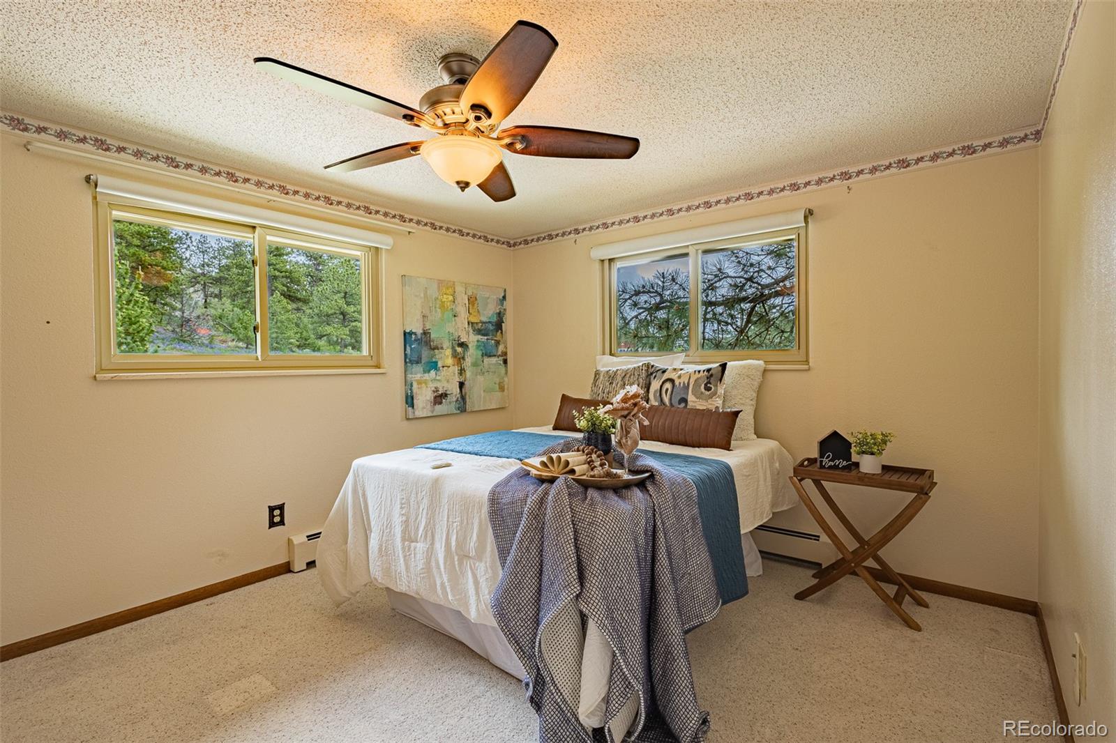 98 Button Rock Road Lyons, CO 80540 - Photo 14 of 40 a bed room with a bed and a chandelier