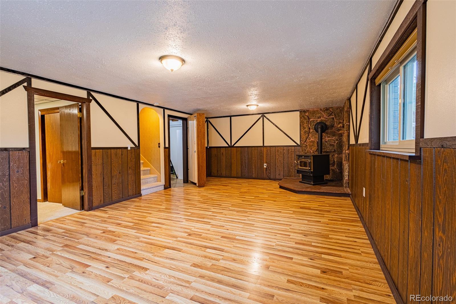 98 Button Rock Road Lyons, CO 80540 - Photo 18 of 40 a bedroom with wooden floor and window