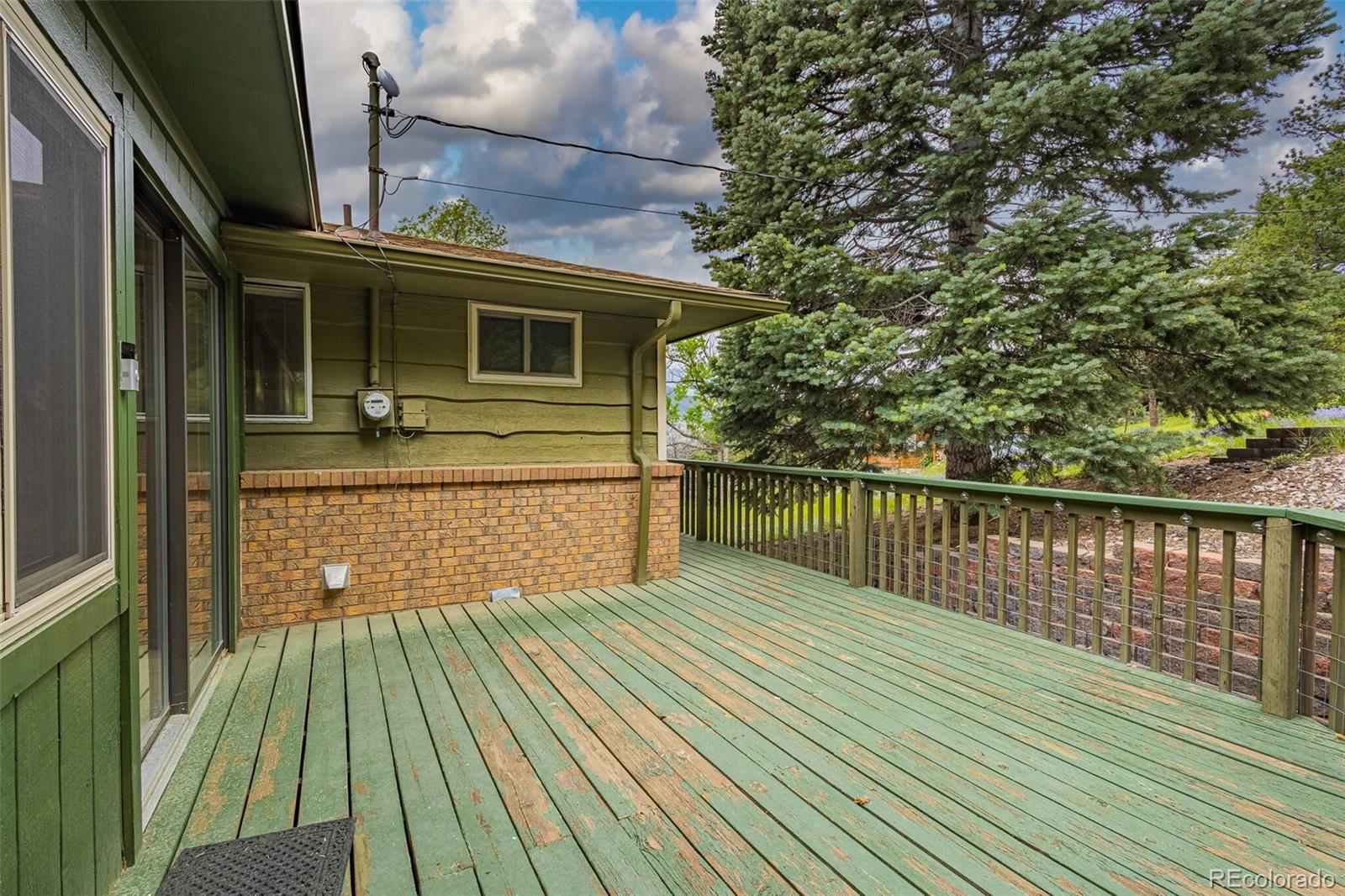 98 Button Rock Road Lyons, CO 80540 - Photo 24 of 40 a view of a house with a wooden deck