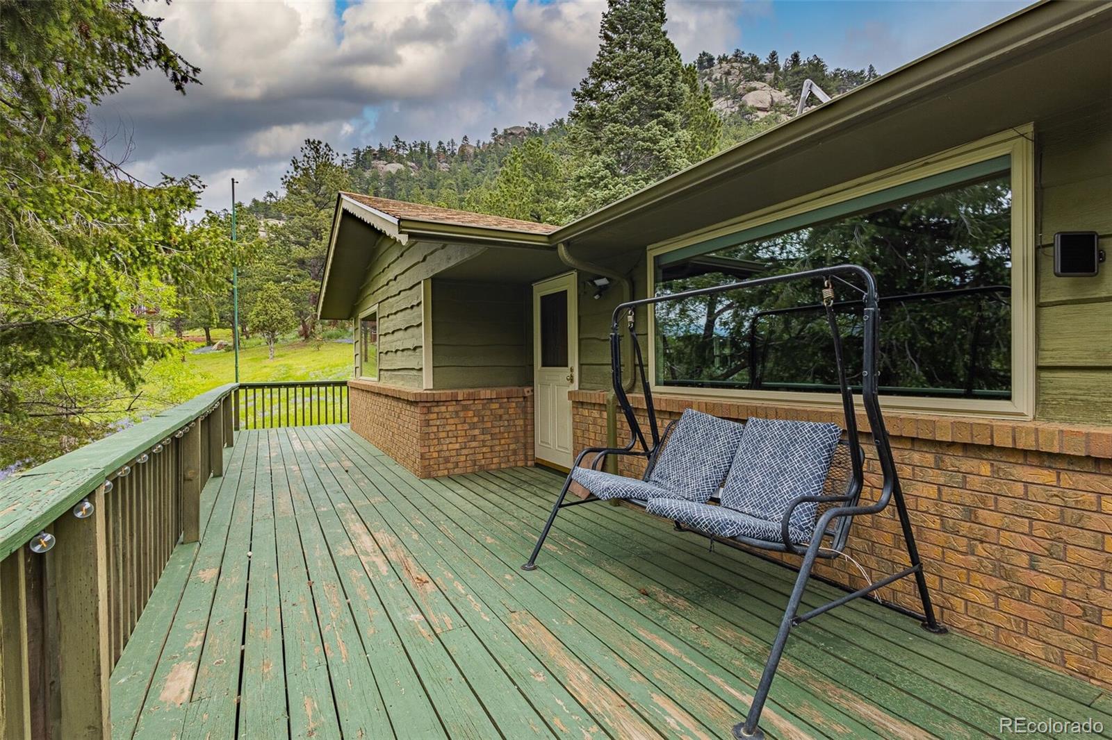 98 Button Rock Road Lyons, CO 80540 - Photo 25 of 40 a view of balcony with wooden floor and outdoor space