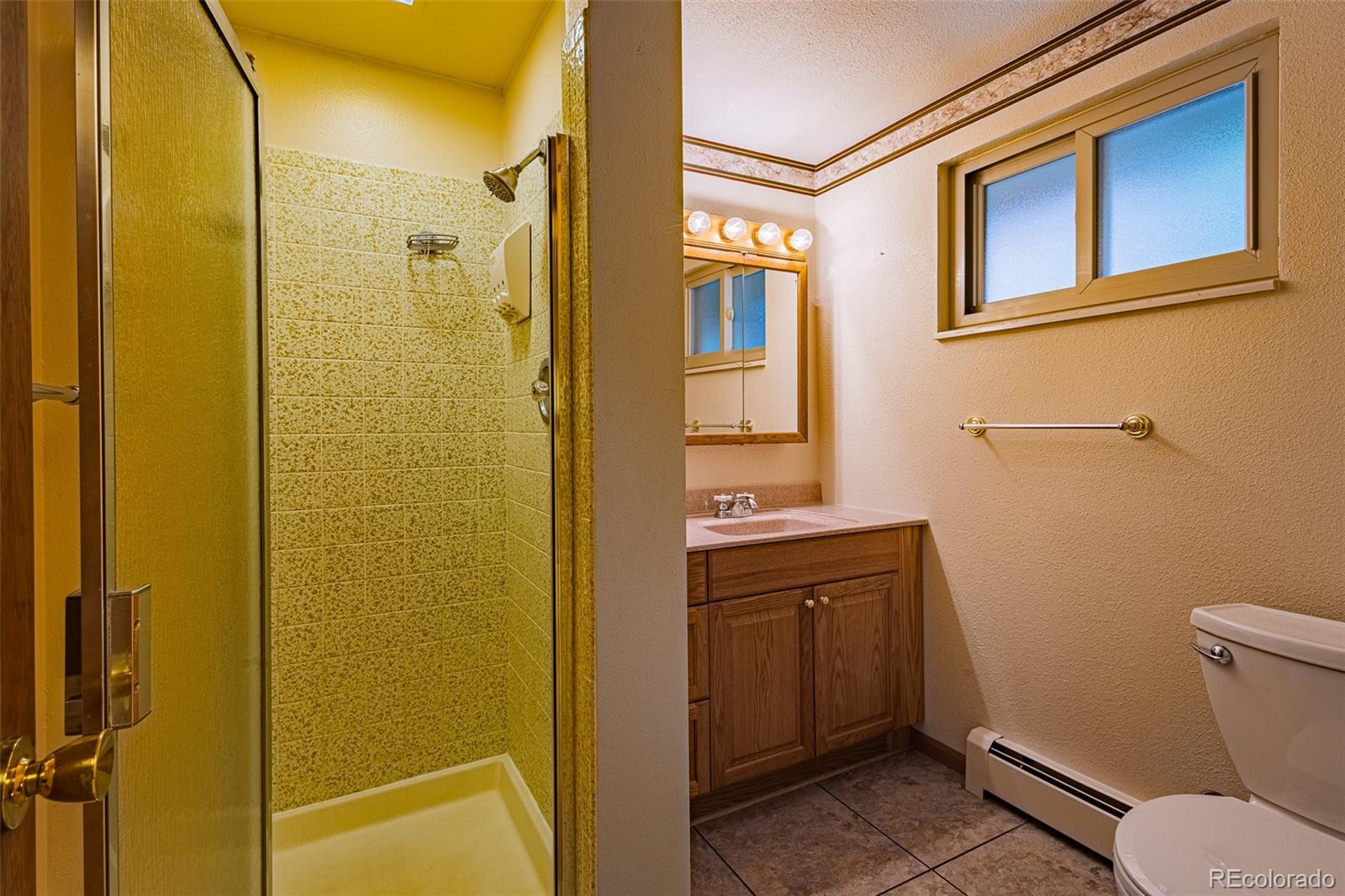 98 Button Rock Road Lyons, CO 80540 - Photo 29 of 40 a bathroom with a sink and mirror with toilet